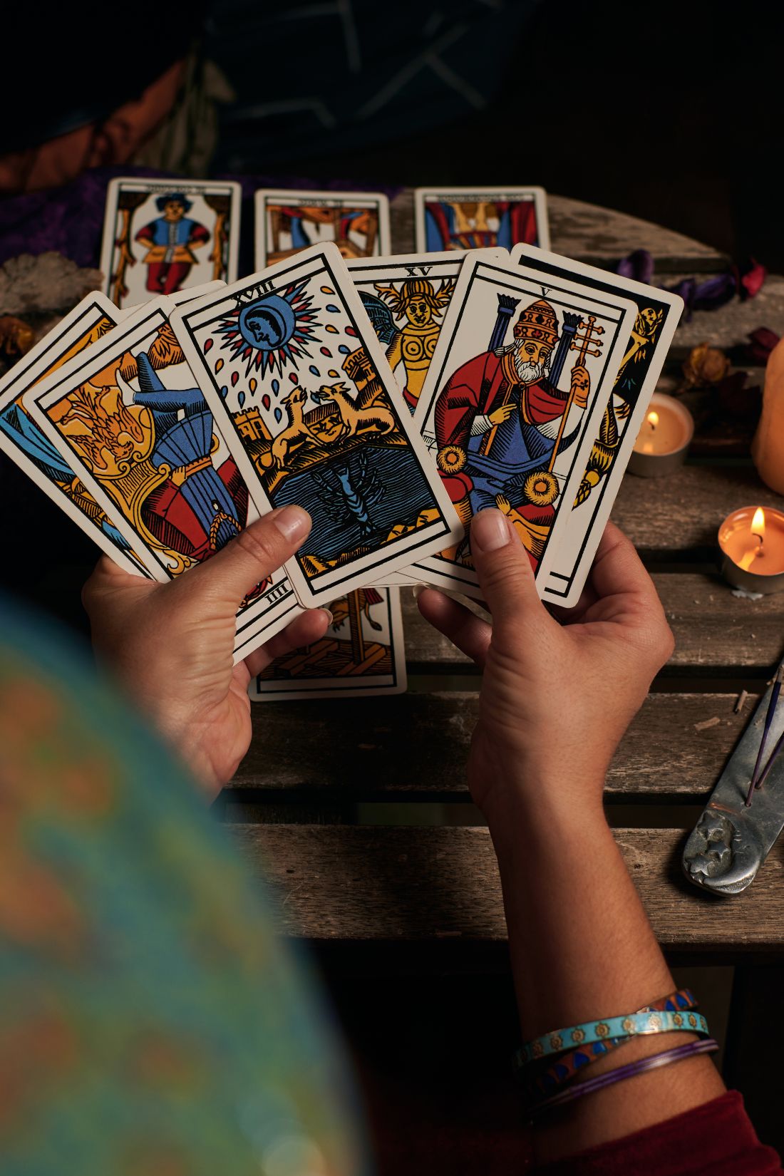 Close up of a fortune teller reading tarot cards